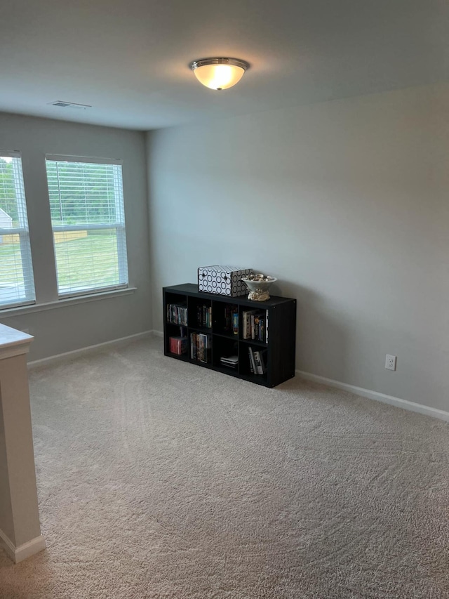 empty room featuring carpet flooring and baseboards