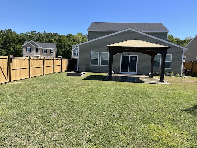 back of property featuring a gazebo, a patio area, and a fire pit