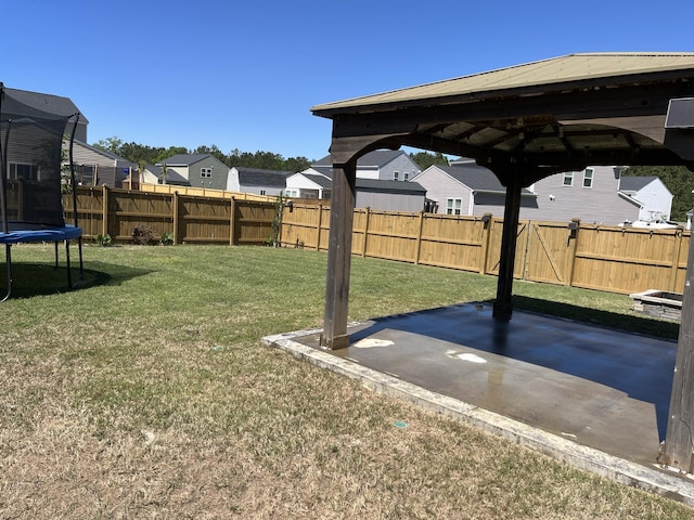 view of yard with a trampoline, a patio, a gazebo, and a residential view