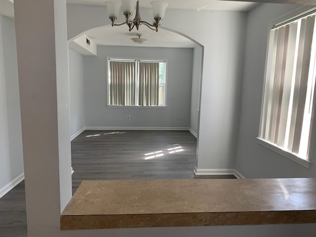 105 S Merriman Rd, Georgetown, SC 29440 - spare room with arched walkways, a chandelier, and wood finished floors