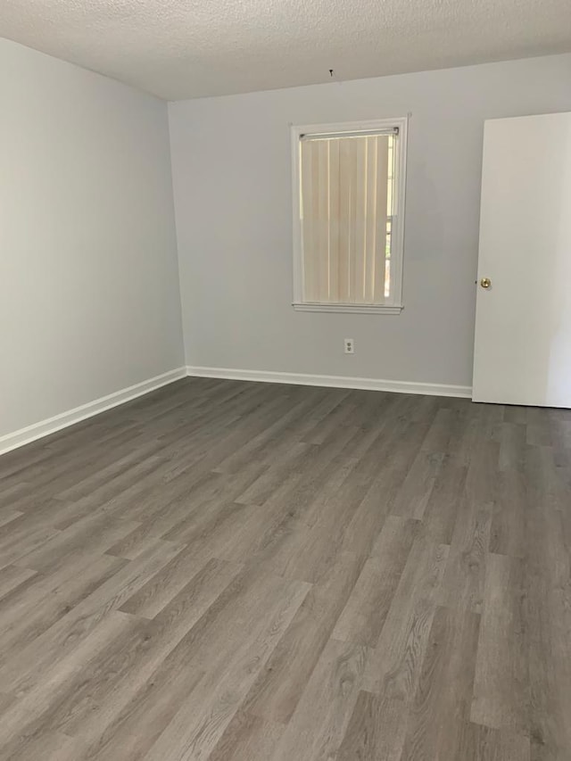 105 S Merriman Rd, Georgetown, SC 29440 - empty room with wood finished floors and a textured ceiling