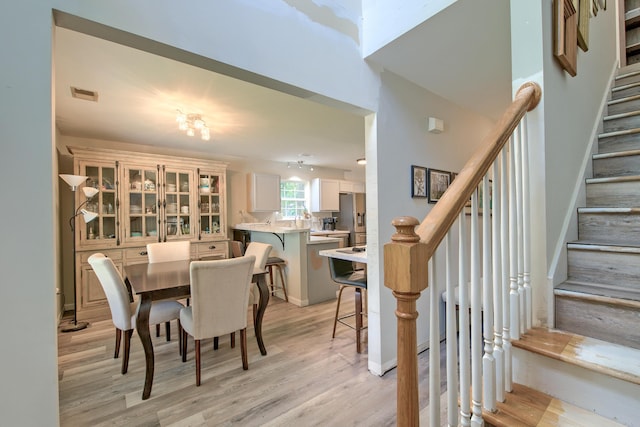2538 Wayne Scott Ct, Charleston, SC 29414 - dining space with stairs and light wood-style floors