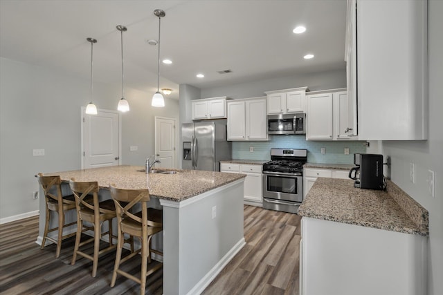 111 Nolin Rd, Moncks Corner, SC 29461 - kitchen with stainless steel appliances, a sink, wood finished floors, white cabinetry, and recessed lighting