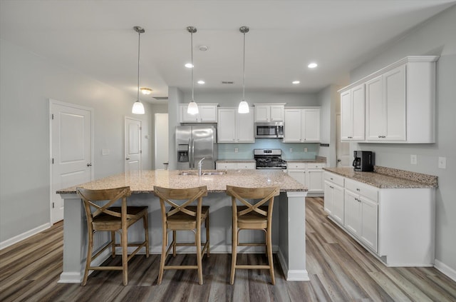 111 Nolin Rd, Moncks Corner, SC 29461 - kitchen with appliances with stainless steel finishes, wood finished floors, white cabinets, and recessed lighting