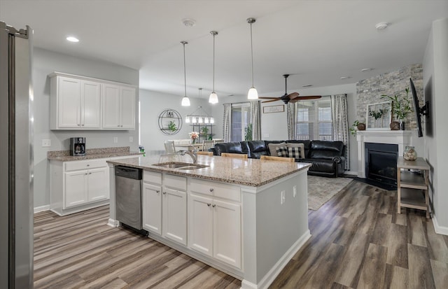 111 Nolin Rd, Moncks Corner, SC 29461 - kitchen featuring a sink, stainless steel appliances, wood finished floors, open floor plan, and white cabinetry
