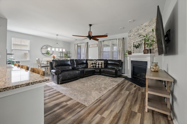 111 Nolin Rd, Moncks Corner, SC 29461 - living area featuring wood finished floors, ceiling fan, a glass covered fireplace, and a chandelier