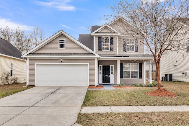 view of front of house with cooling unit, a garage, a front lawn, and a porch