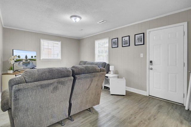 3428 Plaza Ln, North Charleston, SC 29420 - living room featuring healthy amount of natural light, wood finished floors, crown molding, and baseboards