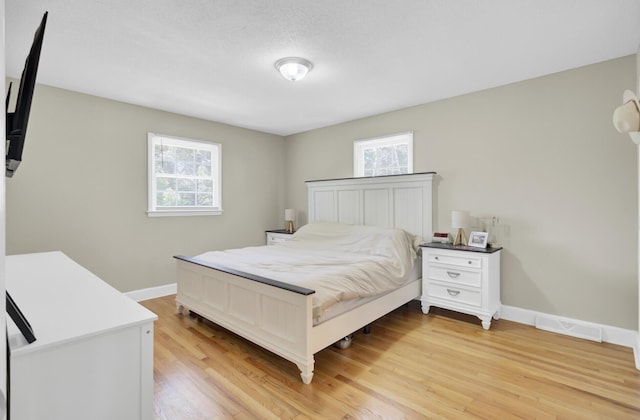 3428 Plaza Ln, North Charleston, SC 29420 - bedroom with multiple windows, light wood finished floors, and baseboards
