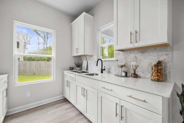 1387 Thin Pine Dr, Johns Island, SC 29455 - kitchen featuring a sink, tasteful backsplash, white cabinets, and light countertops