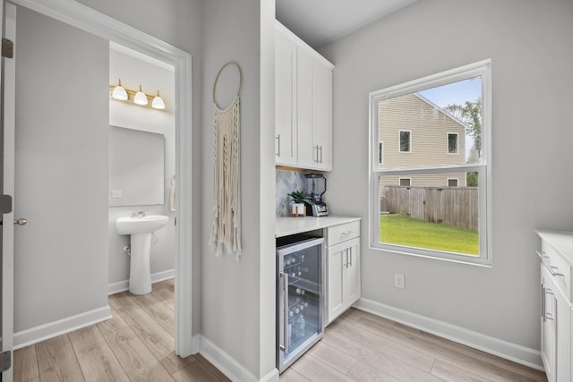 1387 Thin Pine Dr, Johns Island, SC 29455 - indoor dry bar with beverage cooler, light wood-style flooring, and baseboards
