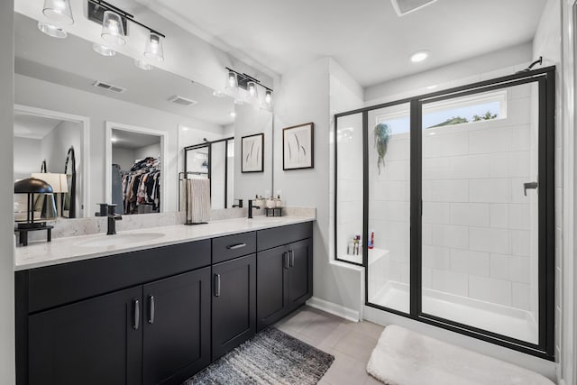 1387 Thin Pine Dr, Johns Island, SC 29455 - bathroom with a shower stall, double vanity, a walk in closet, and tile patterned floors