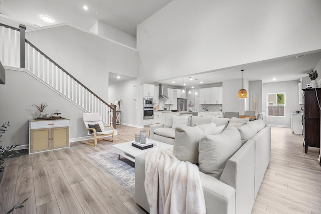 1387 Thin Pine Dr, Johns Island, SC 29455 - living room with stairway, light wood-type flooring, baseboards, a towering ceiling, and recessed lighting