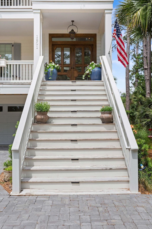 doorway to property with a porch and french doors
