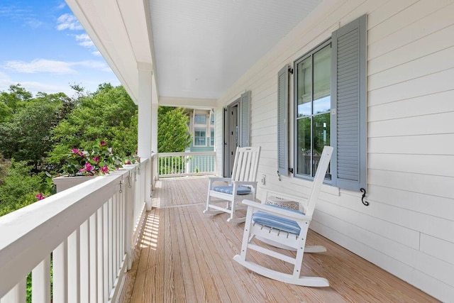 wooden terrace featuring covered porch
