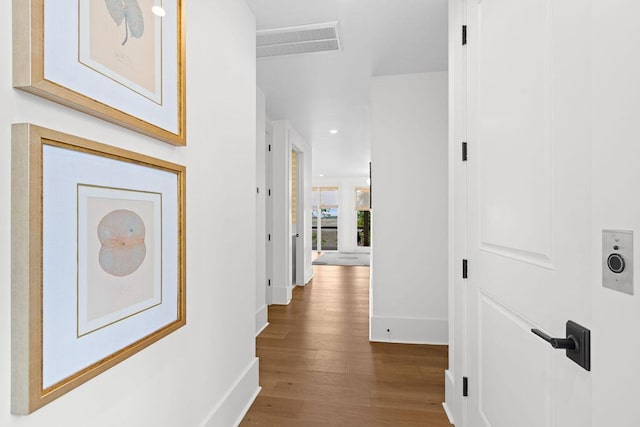 hallway with recessed lighting, baseboards, visible vents, and wood finished floors