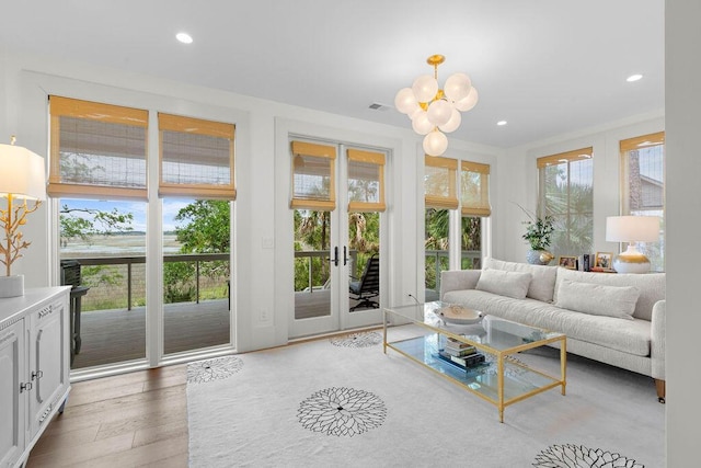 living area featuring a chandelier, wood finished floors, visible vents, and recessed lighting