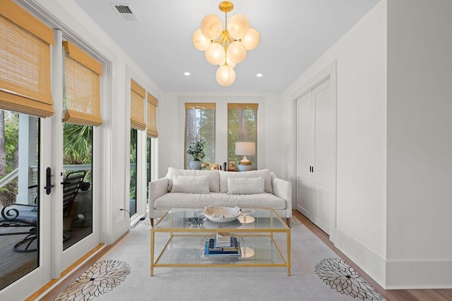 interior space with recessed lighting, visible vents, wood finished floors, and a notable chandelier