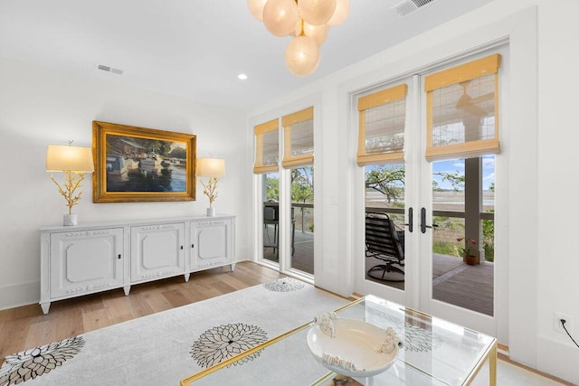 doorway featuring recessed lighting, light wood-style floors, and visible vents