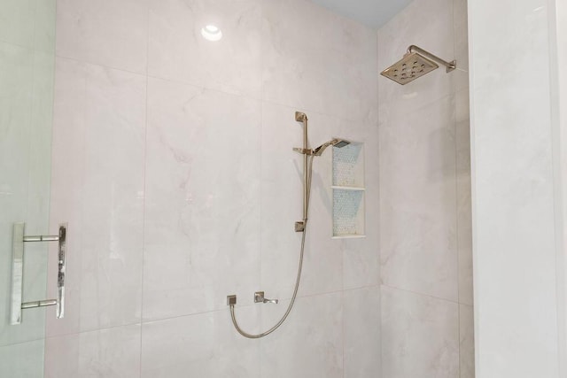 full bath with a tile shower