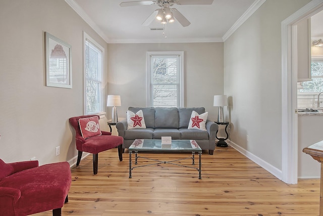 living area featuring crown molding, ceiling fan, and light hardwood / wood-style flooring