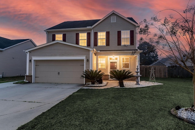 traditional home featuring concrete driveway, a front yard, and fence