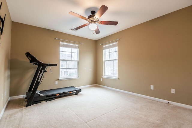 exercise room featuring visible vents, carpet flooring, baseboards, and a ceiling fan