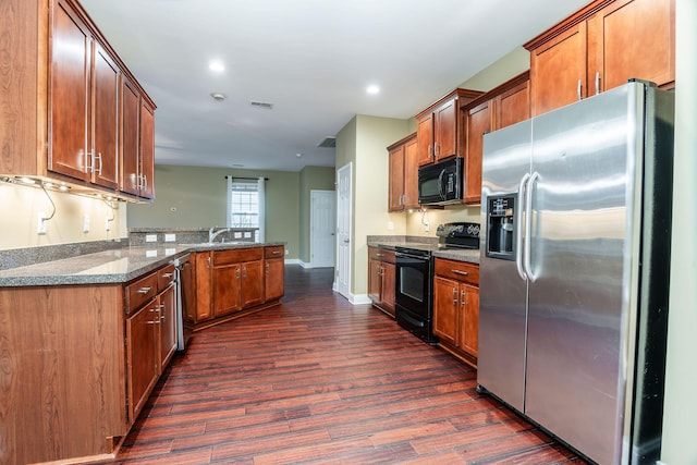 kitchen with visible vents, black appliances, and brown cabinetry