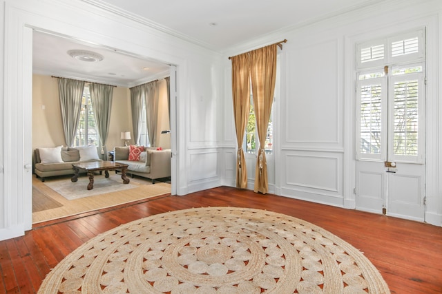 foyer with hardwood / wood-style flooring and ornamental molding