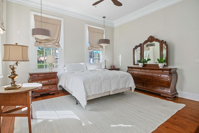 bedroom featuring crown molding, hardwood / wood-style floors, and ceiling fan