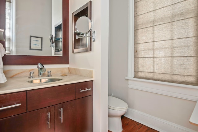 bathroom with vanity, hardwood / wood-style flooring, and toilet