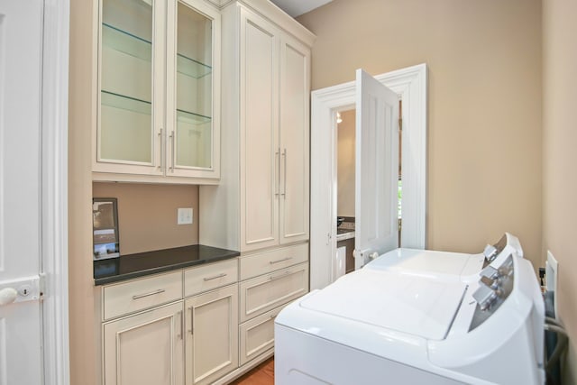 laundry area featuring cabinets and washing machine and dryer