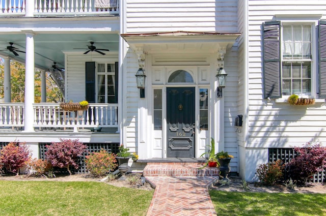 property entrance featuring a balcony, ceiling fan, and covered porch