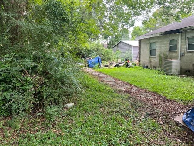 view of yard with central air condition unit