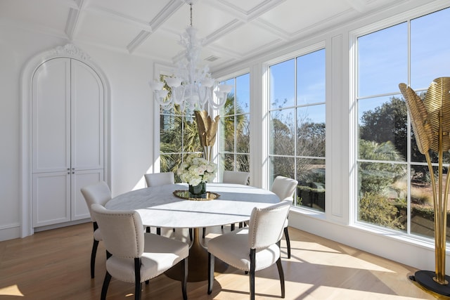 sunroom / solarium with beamed ceiling, coffered ceiling, and a notable chandelier