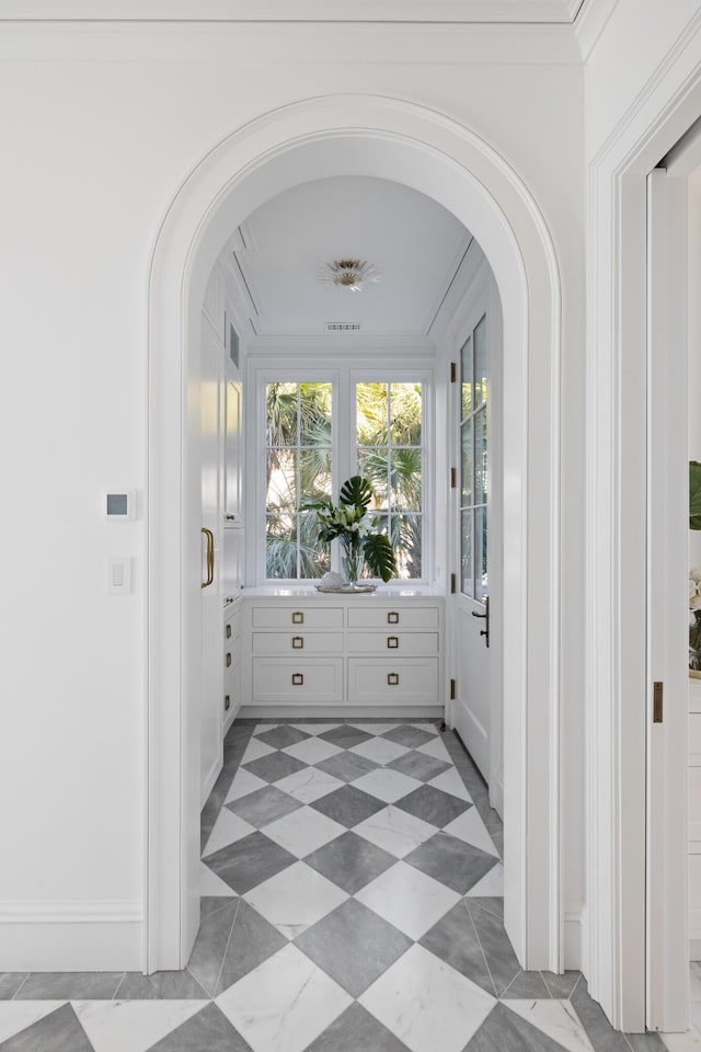 interior space featuring a wealth of natural light and ornamental molding