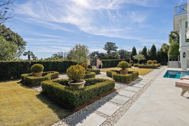 view of yard with a balcony, a fenced in pool, and a patio area