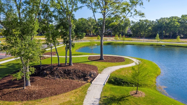 view of community with a water view and a yard