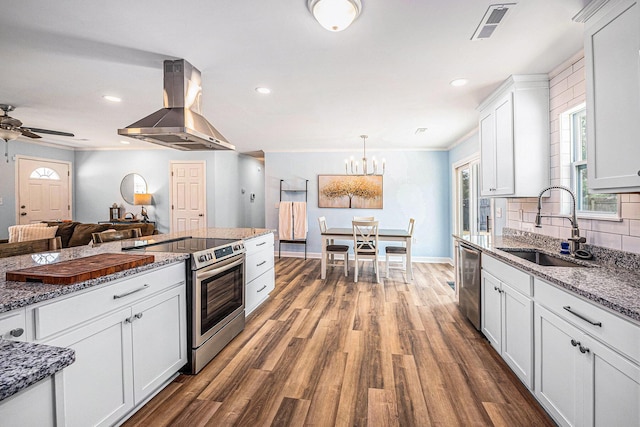 kitchen featuring ventilation hood, stainless steel appliances, a sink, dark wood finished floors, and white cabinets