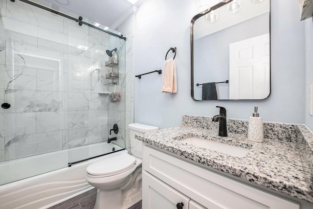 full bathroom with wood finished floors, toilet, vanity, and bath / shower combo with glass door