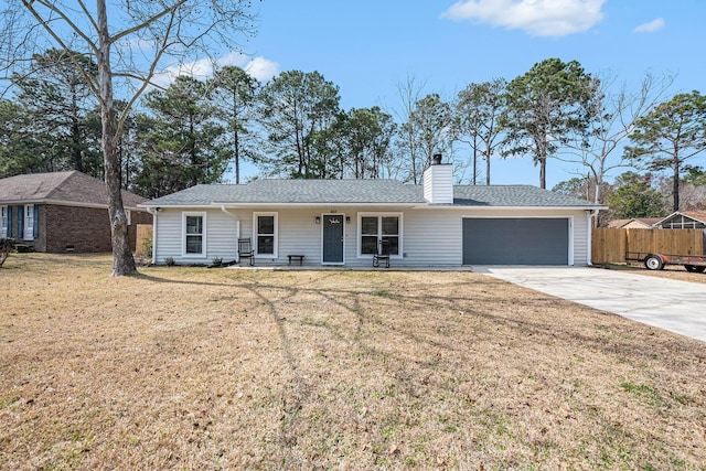 single story home featuring an attached garage, driveway, a chimney, and a shingled roof