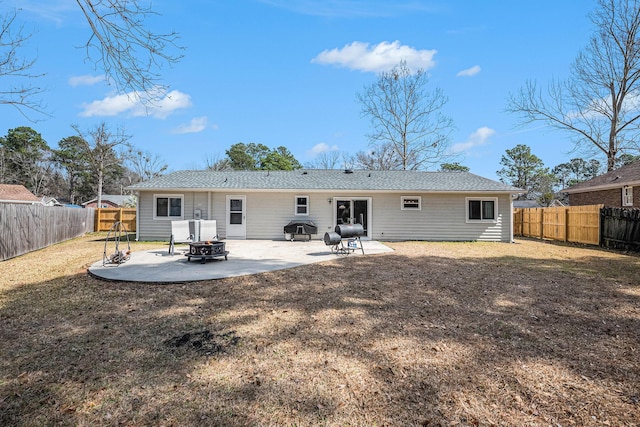 rear view of property featuring an outdoor fire pit and a patio