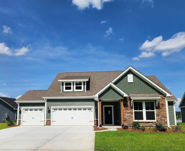 craftsman house featuring a garage and a front yard