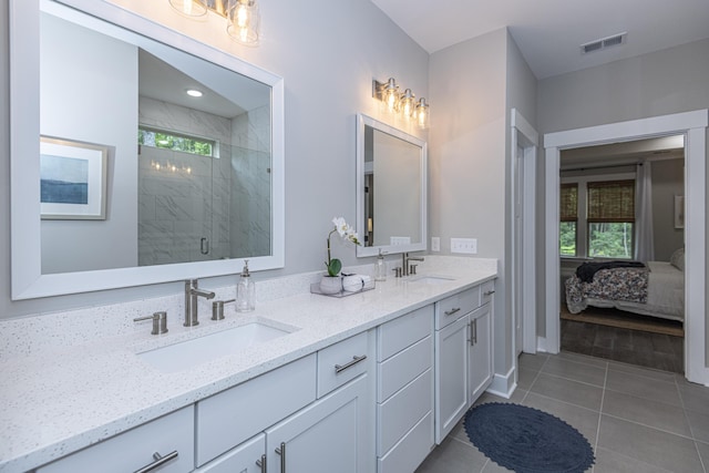 bathroom with tile patterned flooring, vanity, and a shower with door