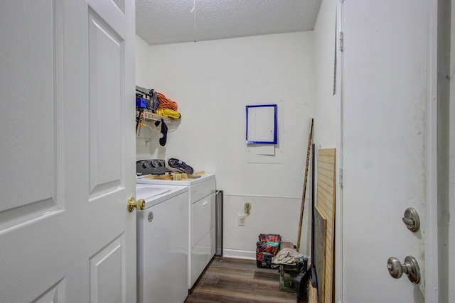 laundry area with a textured ceiling, dark hardwood / wood-style flooring, and separate washer and dryer