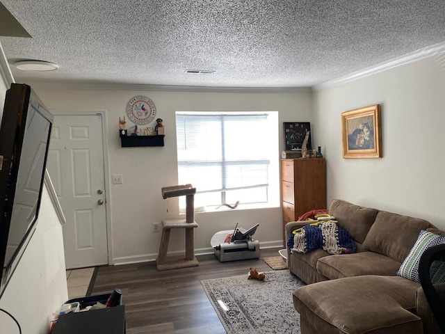 living room featuring crown molding, hardwood / wood-style flooring, and a textured ceiling