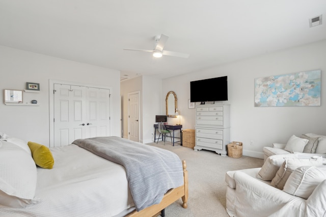 bedroom with light carpet, a closet, and ceiling fan