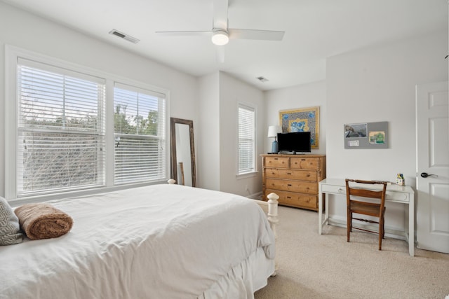 bedroom with ceiling fan and light carpet