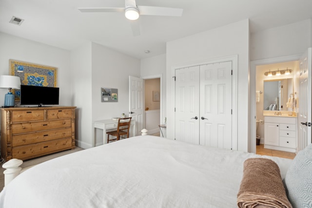 bedroom featuring connected bathroom, a closet, and ceiling fan