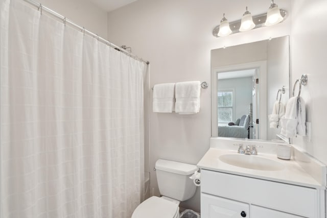 full bathroom with vanity, shower / bath combination with curtain, and toilet